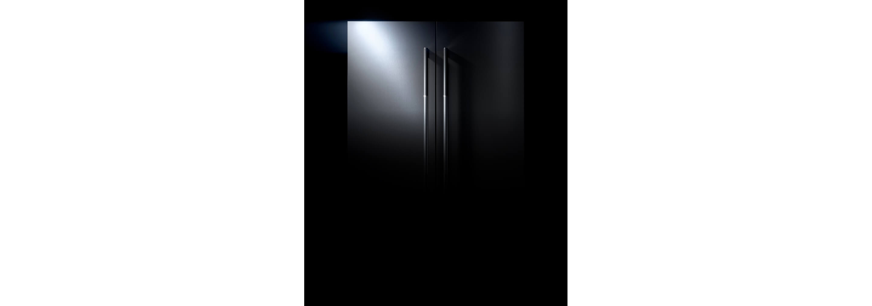 The exterior of a JennAir® refrigerator fitted with RISE™ design panels.