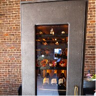 A JennAir® Wine Column with a Cuts Collection Caviar leather panel