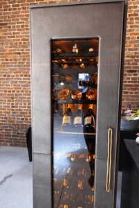 A JennAir® Wine Column with a Cuts Collection Caviar leather panel