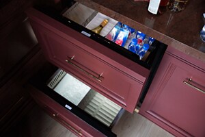 Open JennAir® Refrigerator and Freezer Drawers installed in the bar