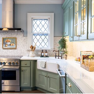 A JennAir® range and range hood installed in the bright kitchen