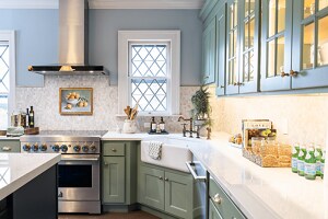 A JennAir® range and range hood installed in the bright kitchen
