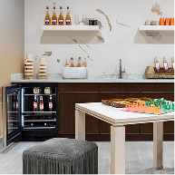 An open JennAir® Undercounter Refrigerator installed in a wet bar