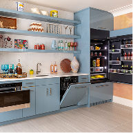 A bright kitchen with blue cabinets, outfitted with JennAir® appliances 