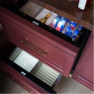Open JennAir® Refrigerator and Freezer Drawers installed in the bar