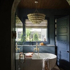 A freestanding bathtub in a blue bathroom