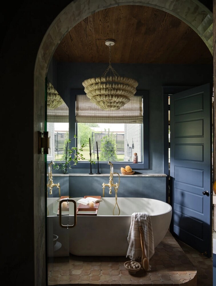 A freestanding bathtub in a blue bathroom