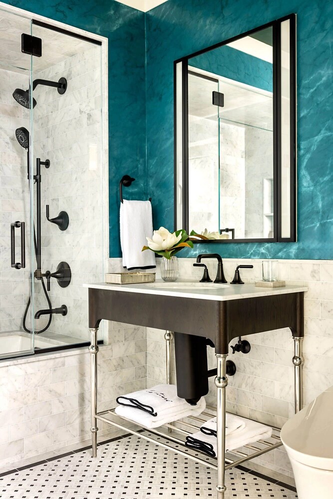 Another angle of the bathroom with a rich teal wall.