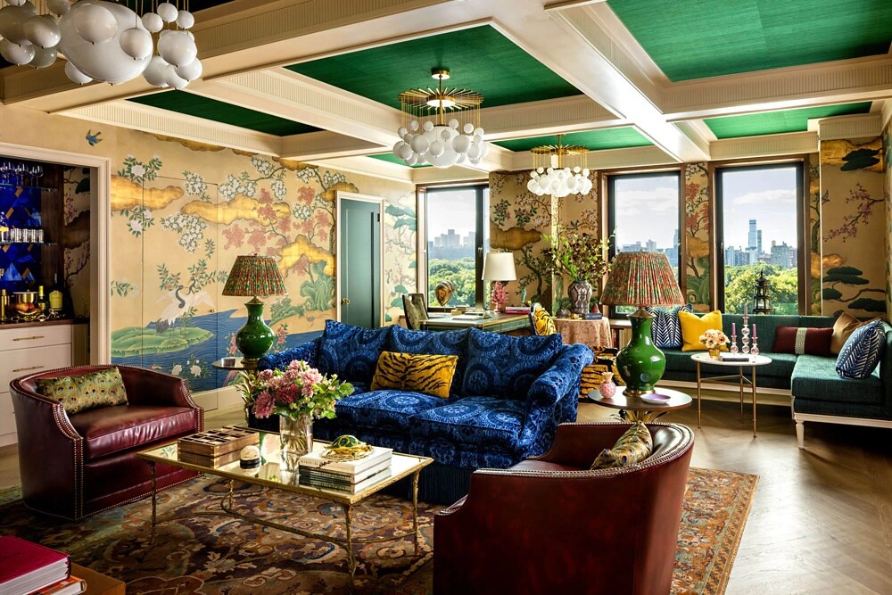A living room filled with color, texture and pattern, including a coffered ceiling.