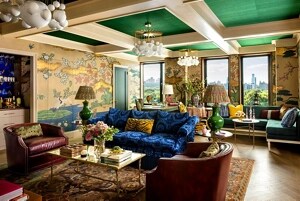 A living room filled with color, texture and pattern, including a coffered ceiling.