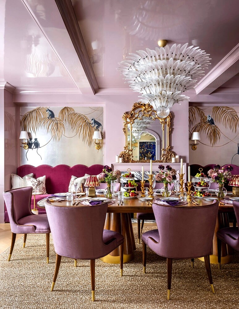 A pale pink dining room with gilded details.
