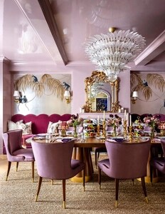 A pale pink dining room with gilded details.