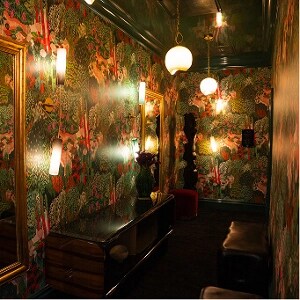A bold  dressing room, designed with patterned wallpaper