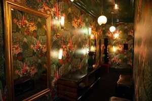 A bold  dressing room, designed with patterned wallpaper