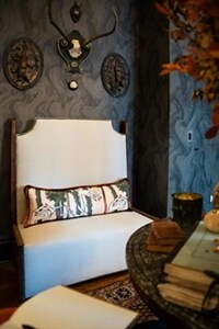 An upholstered bench in a moody room