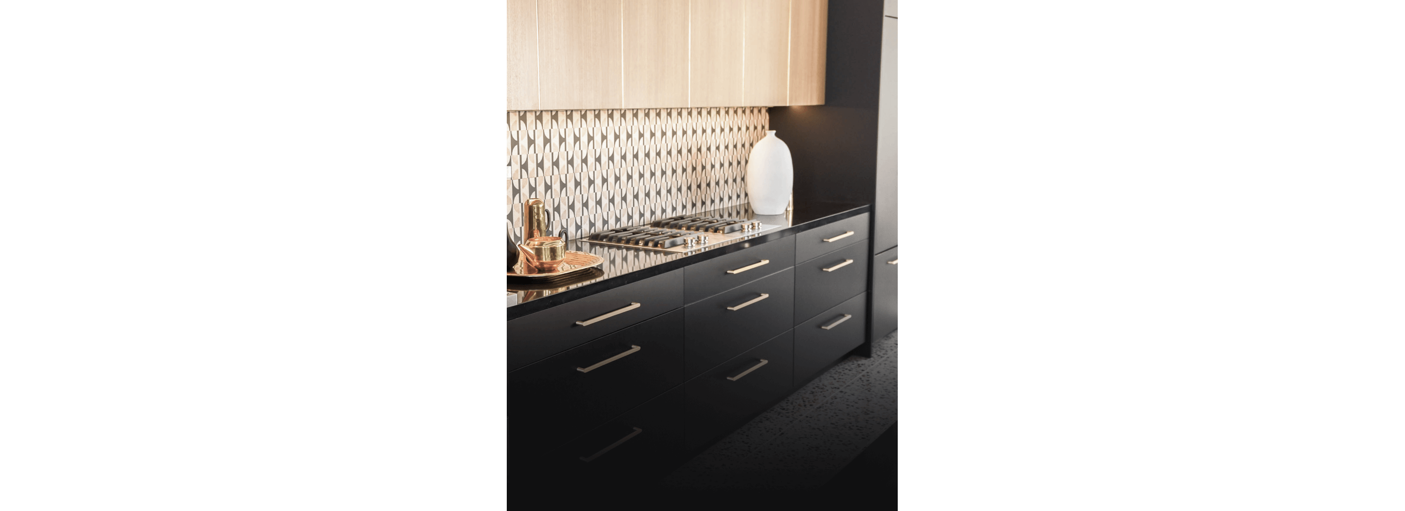A pair of JennAir® Gas Custom Cooktops with a Downdraft Ventilation Strip in the center.