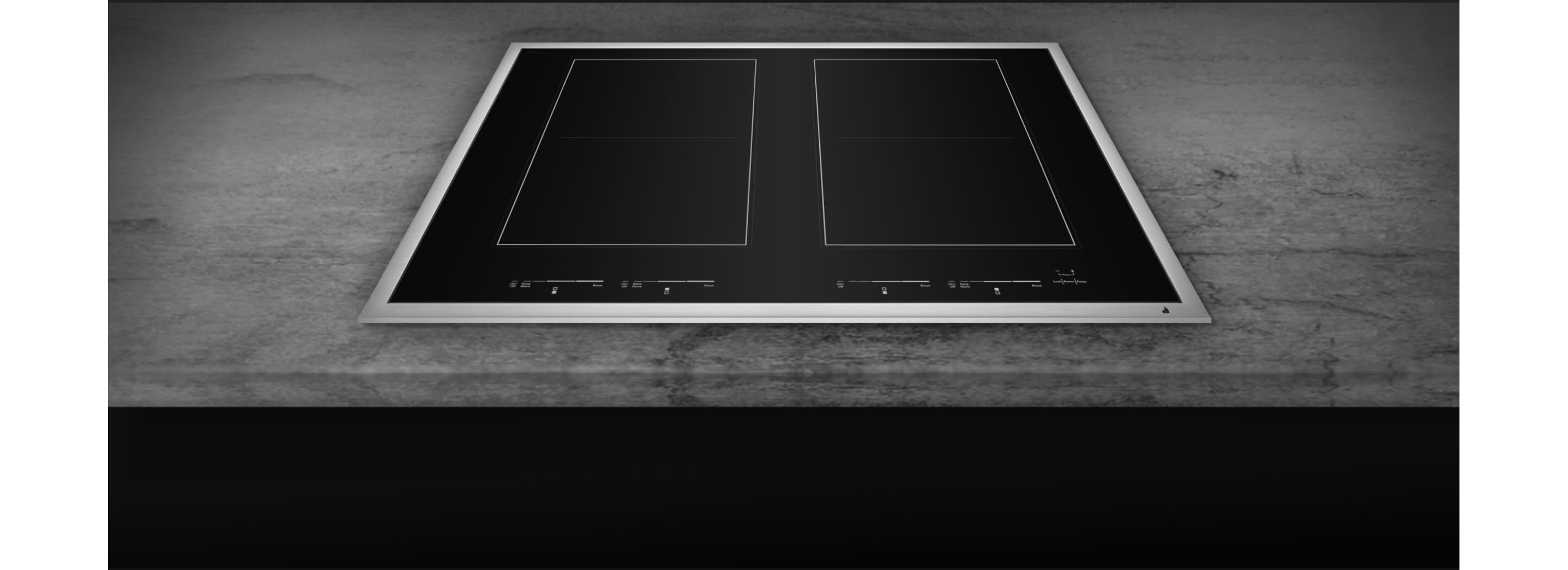 A closeup of the brushed metal frame of a cooktop.