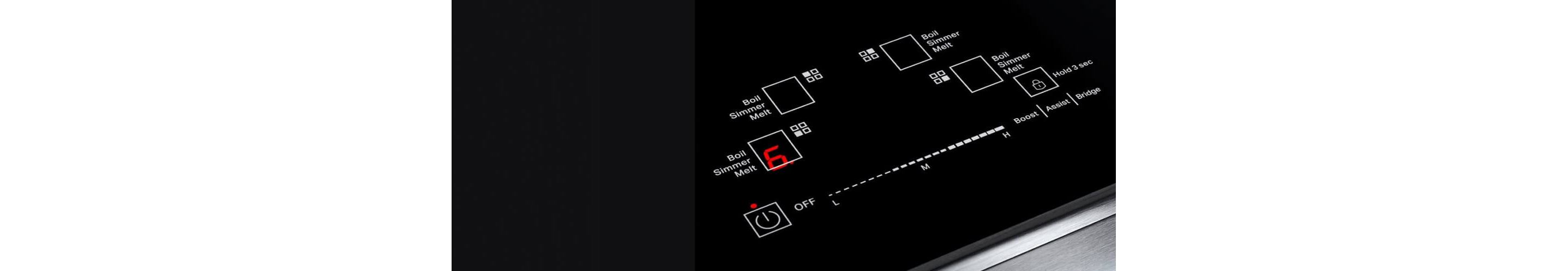 Closeup of lit emotive controls on a cooktop.