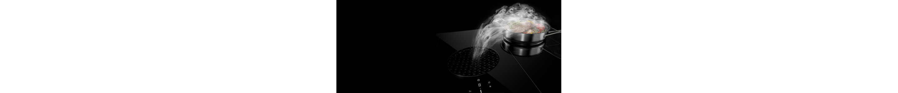 A pan on a downdraft cooktop with the steam pulling into the center vent.
