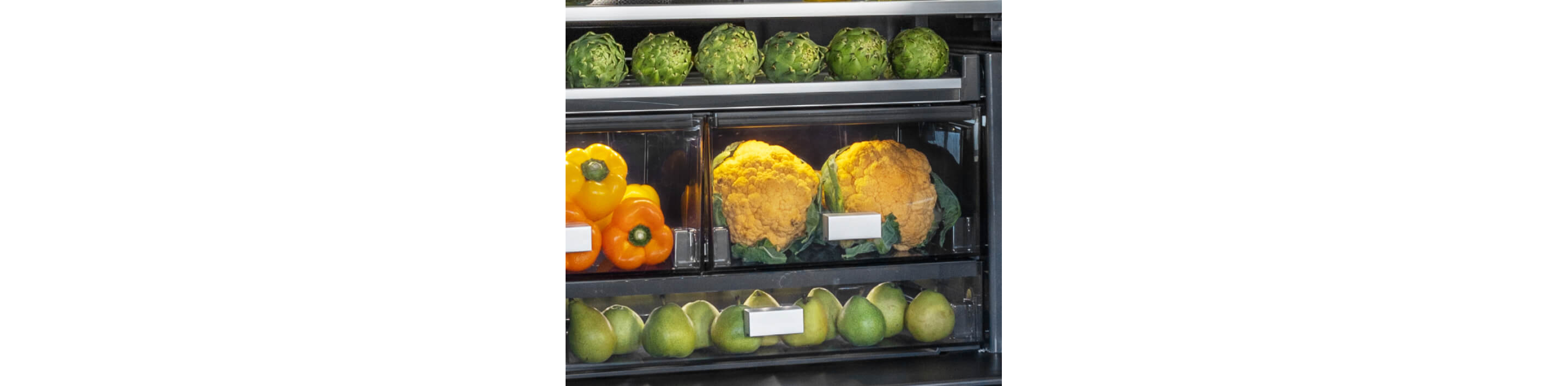 The interior of a freestanding refrigerator filled with vibrant foods and ingredients.