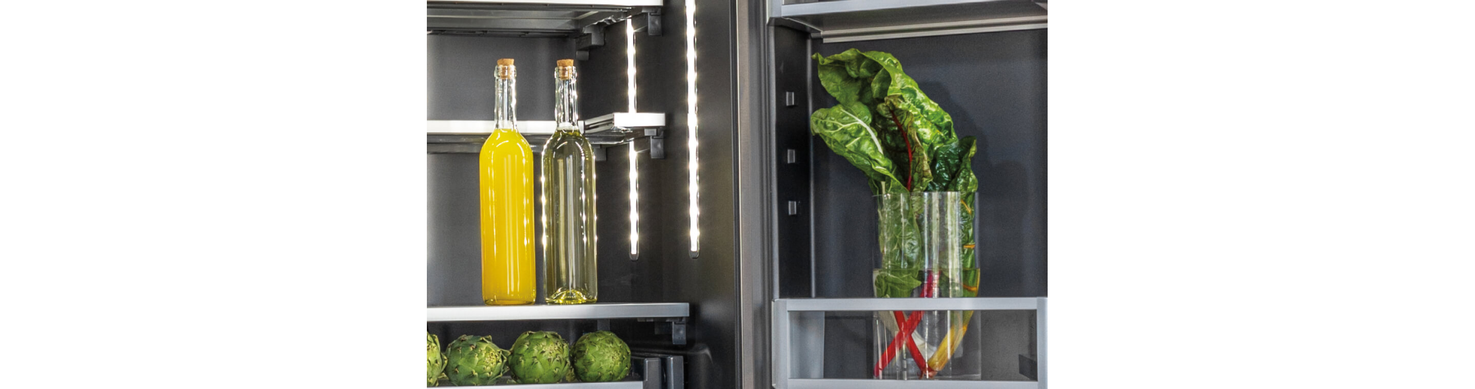 Two tall glass carafes in a JennAir® freestanding refrigerator.