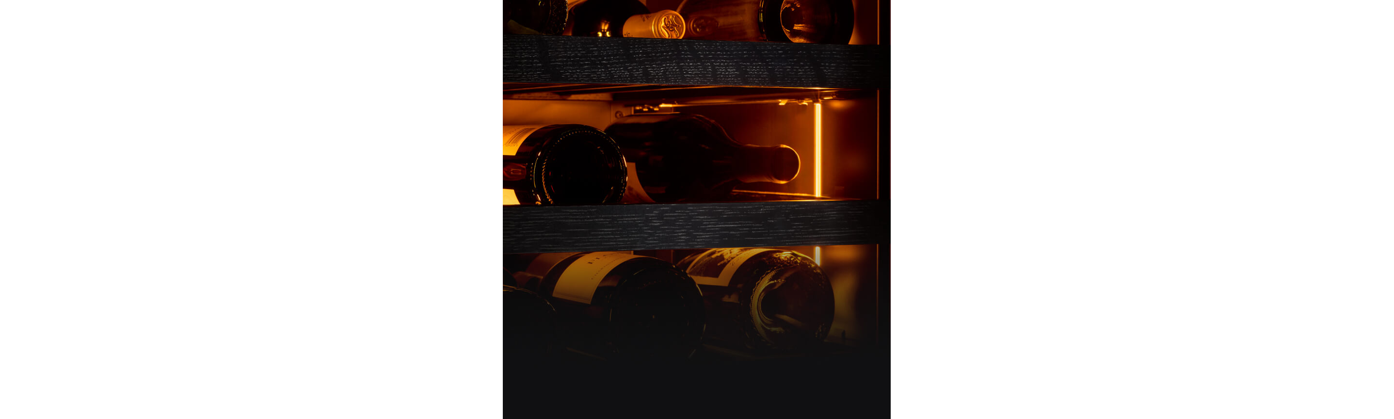 The interior of a wine column bathed in amber colored lighting.