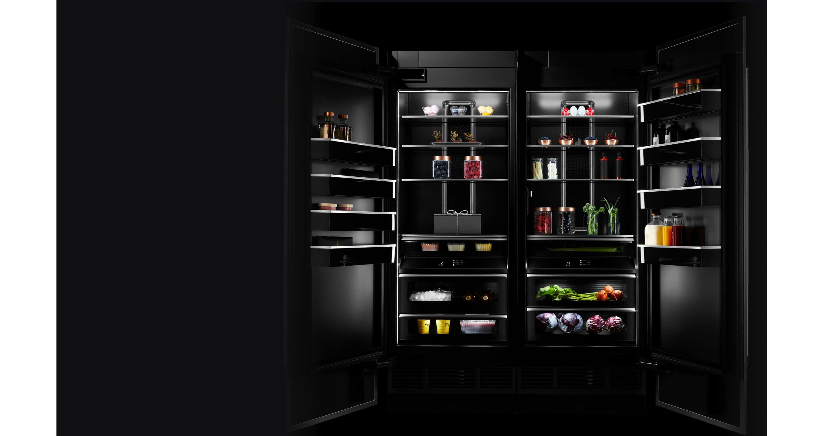 A pair of open JennAir® Columns with an Obsidian Interior, propped with vibrant ingredients.