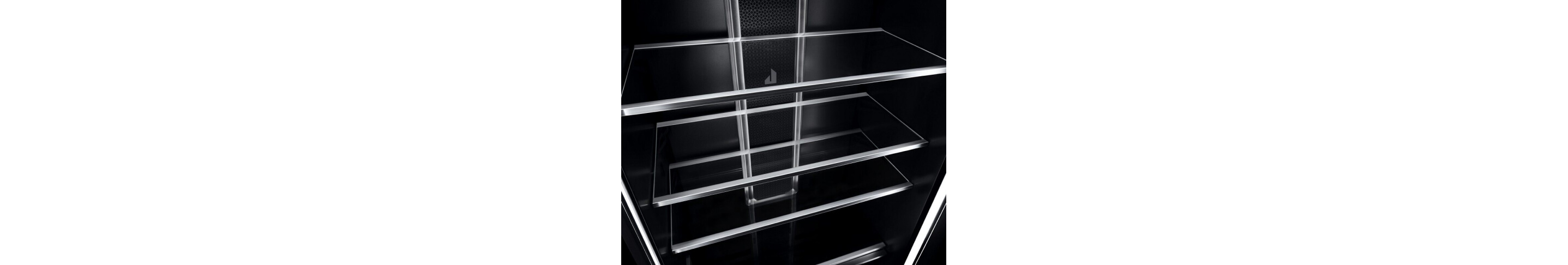 A close up of shelves in a JennAir® Column Refrigerator, showing the crystal-clear glass and metal materials.