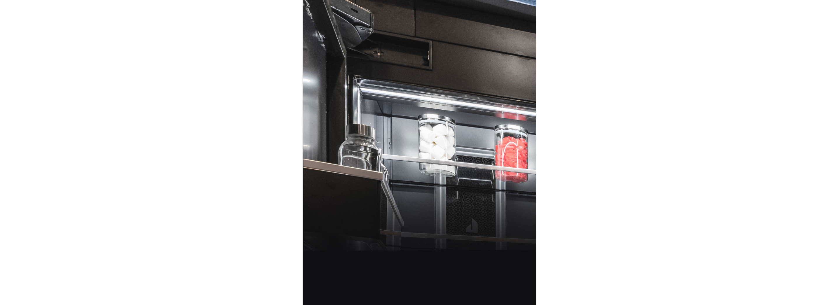 A close up of the hidden hinges on a JennAir® refrigerator.