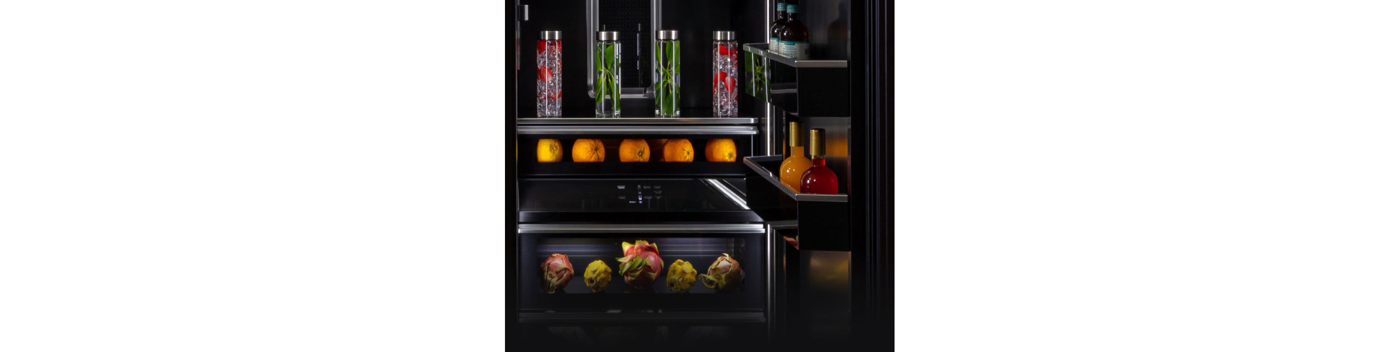 The interior of a refrigerator filled with various fruits, vegetables and herbs.