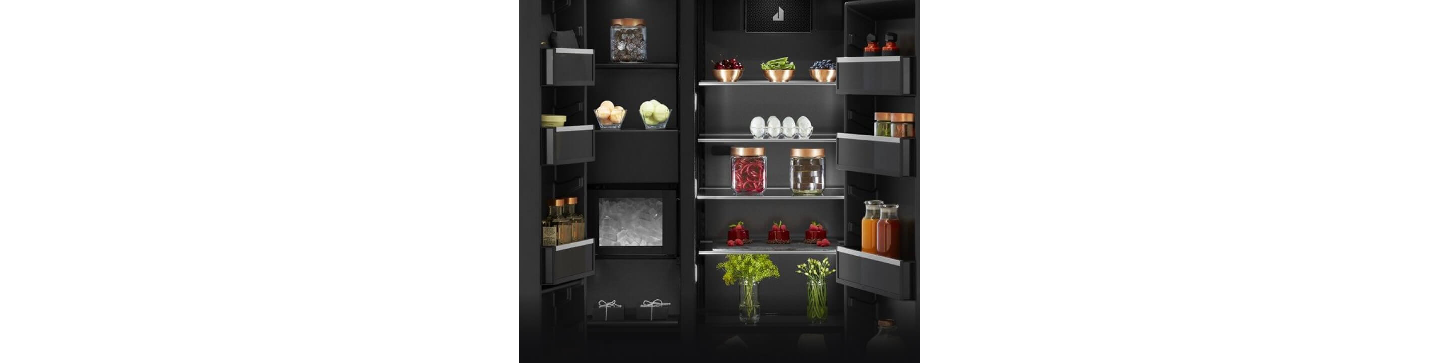 The interior of a built-in refrigerator filled with vibrant foods and ingredients.