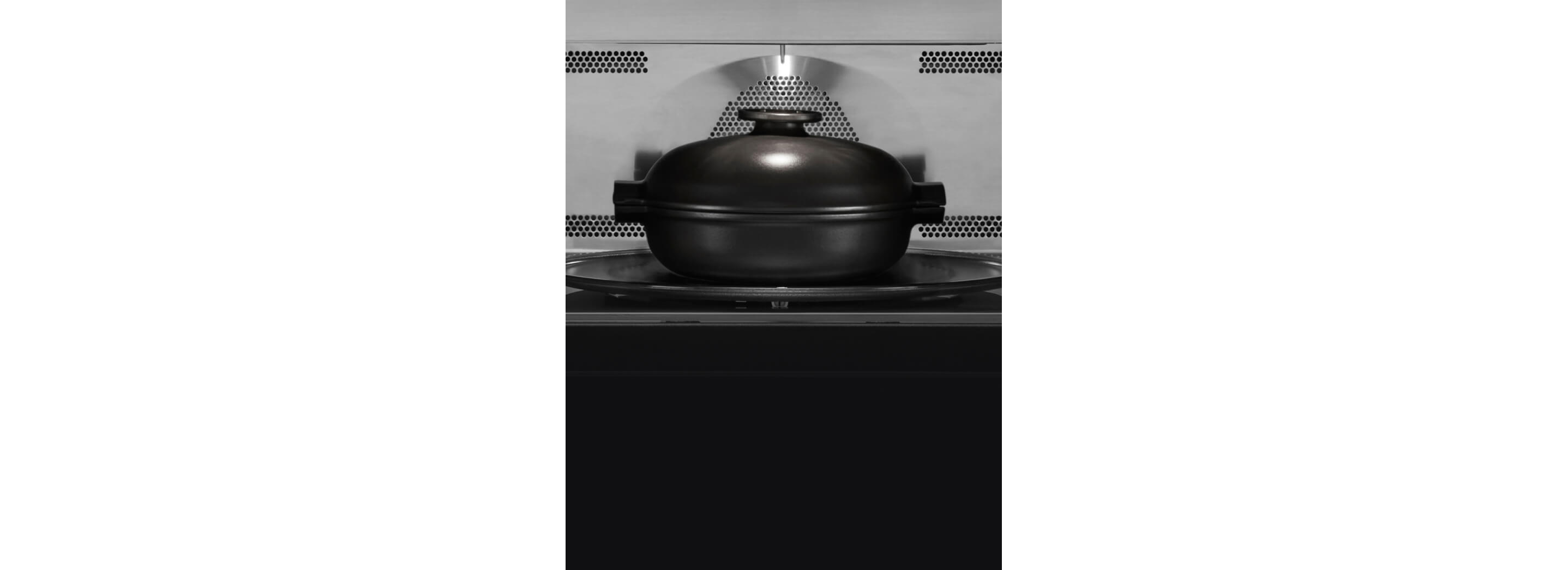 A covered, microwave-safe container inside a microwave.