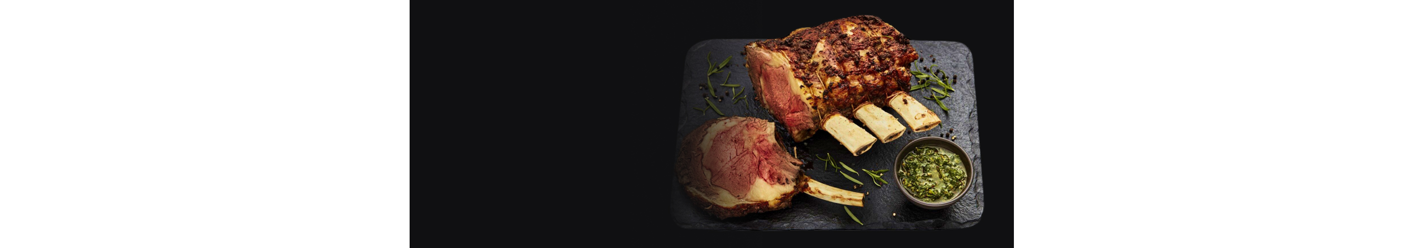 A crown roast on a slate plate.