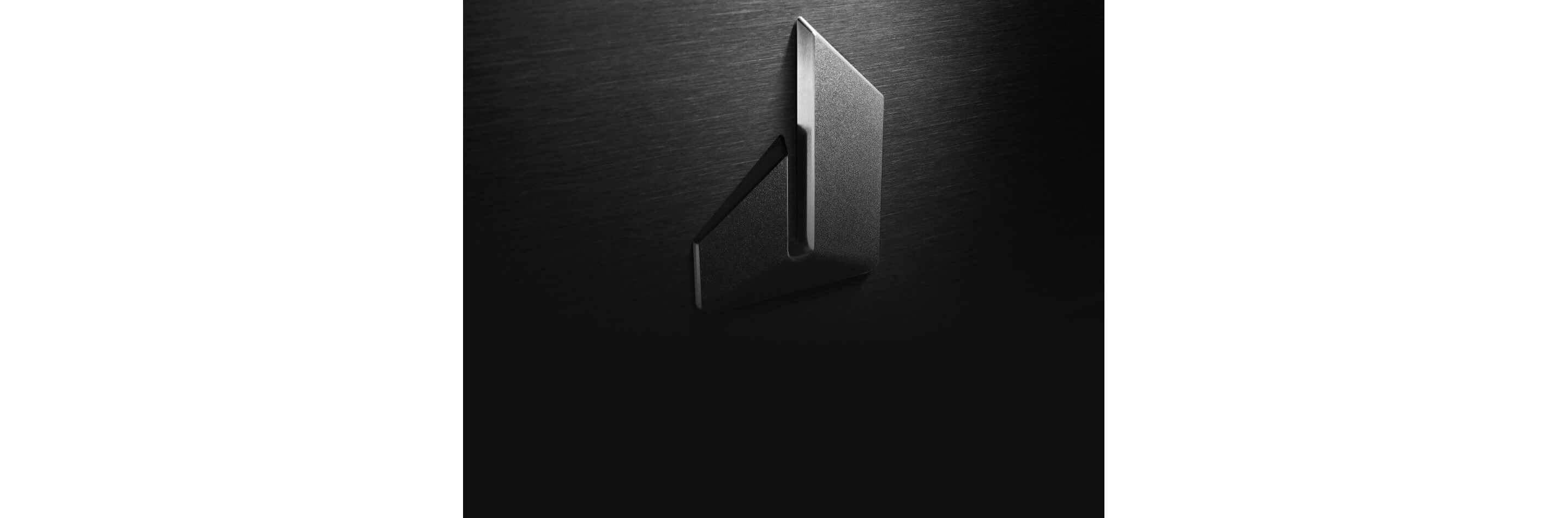 The JennAir defiant J badge isolated on stainless steel.