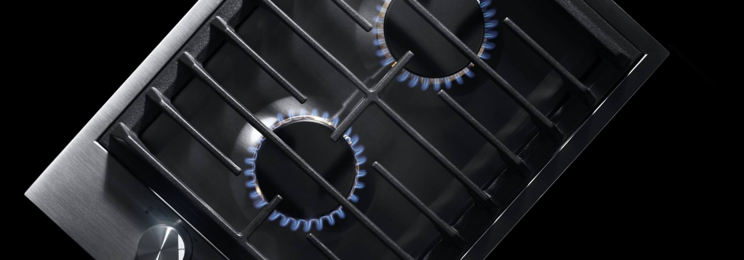 The 2-burner gas cooktop, with its burners lit.