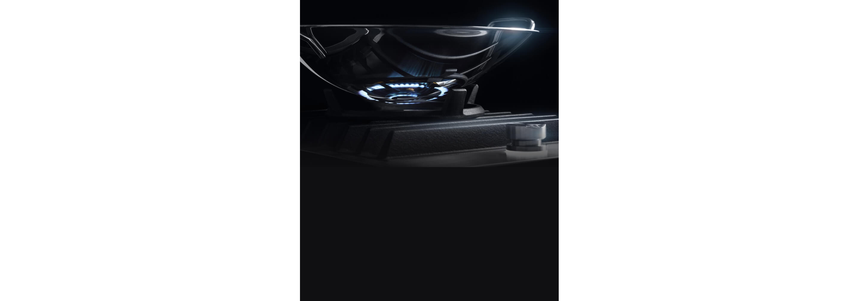 The wok ring on the cooktop, with a stainless steel wok on top.