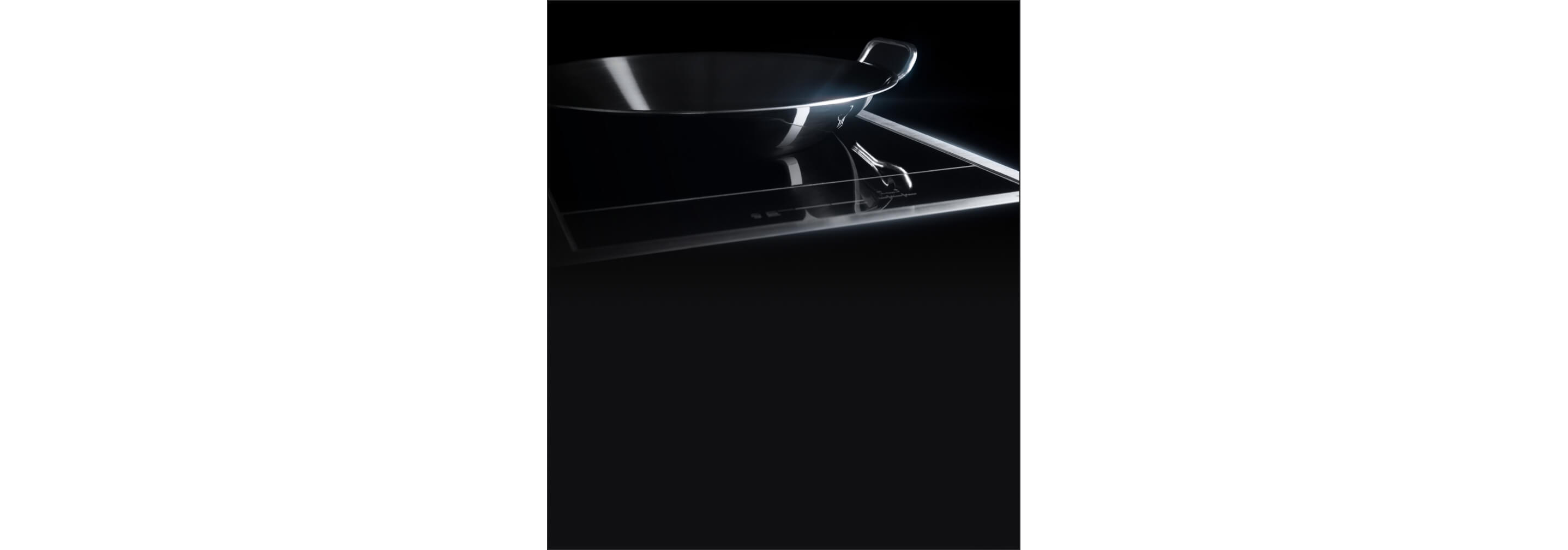 The 15-inch Induction Wok Cooktop with a stainless steel round wok fitting neatly in the concave element.