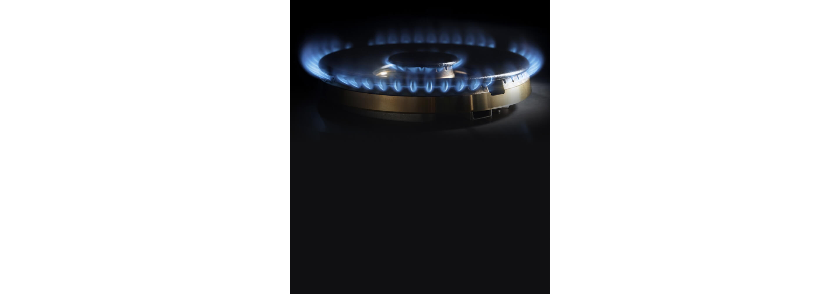 A close-up on the lit brass burner.