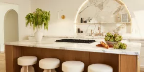 A white luxury kitchen featuring JennAir® appliances.