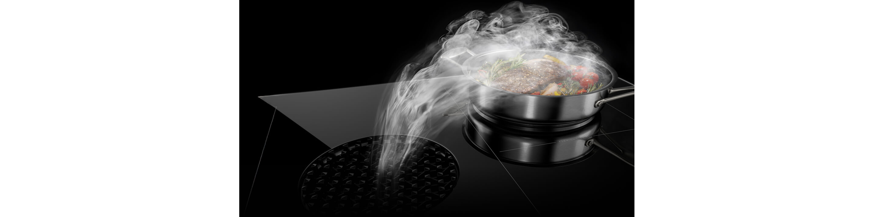 An induction downdraft cooktop pulling steam into the vent in the center.