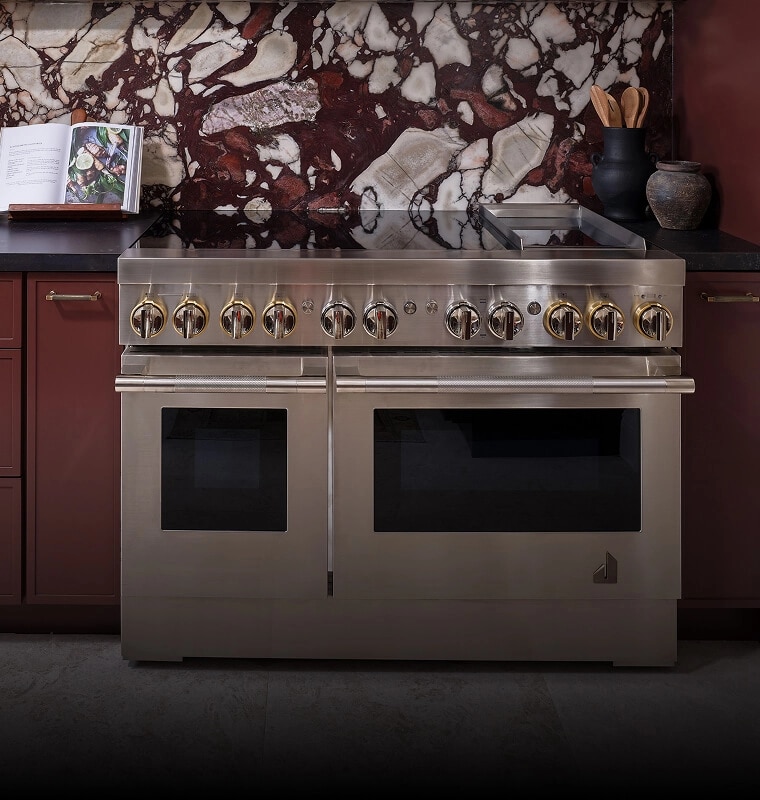 A professional-style range in a burgundy kitchen