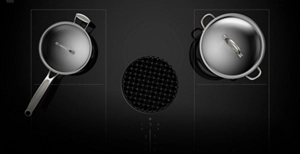 A topdown view of the cooktop with two pans on its surface.
