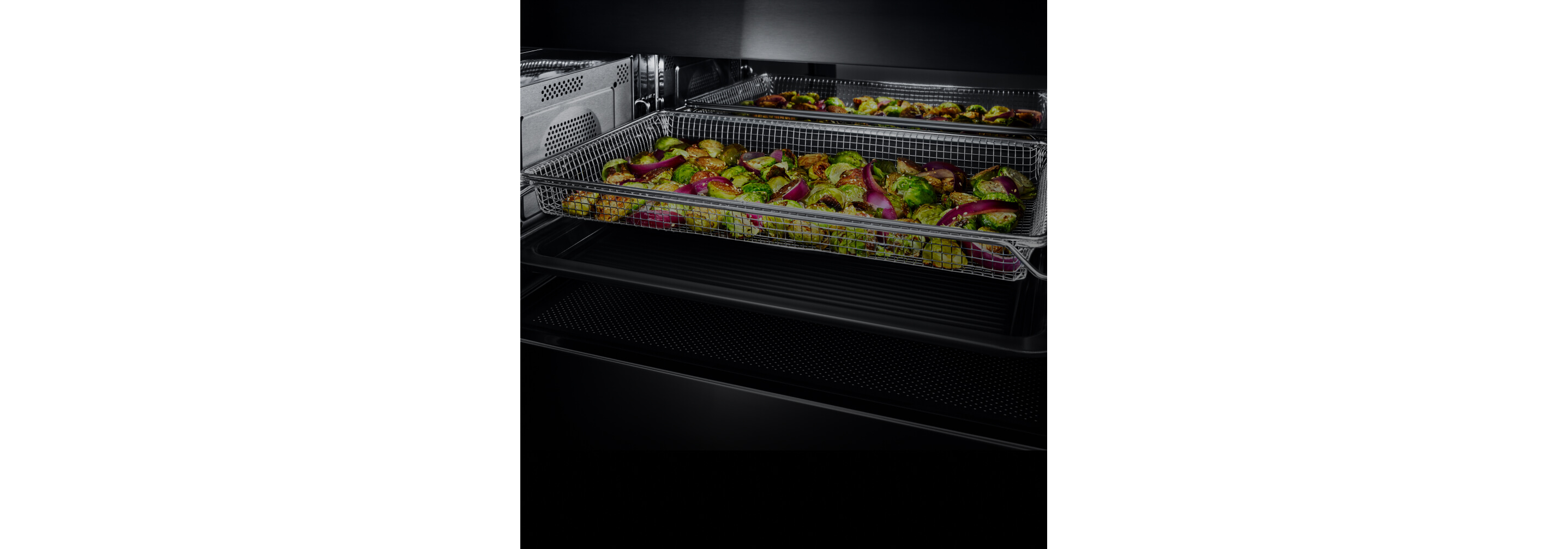 A variety of cut vegetables in an air fry tray.