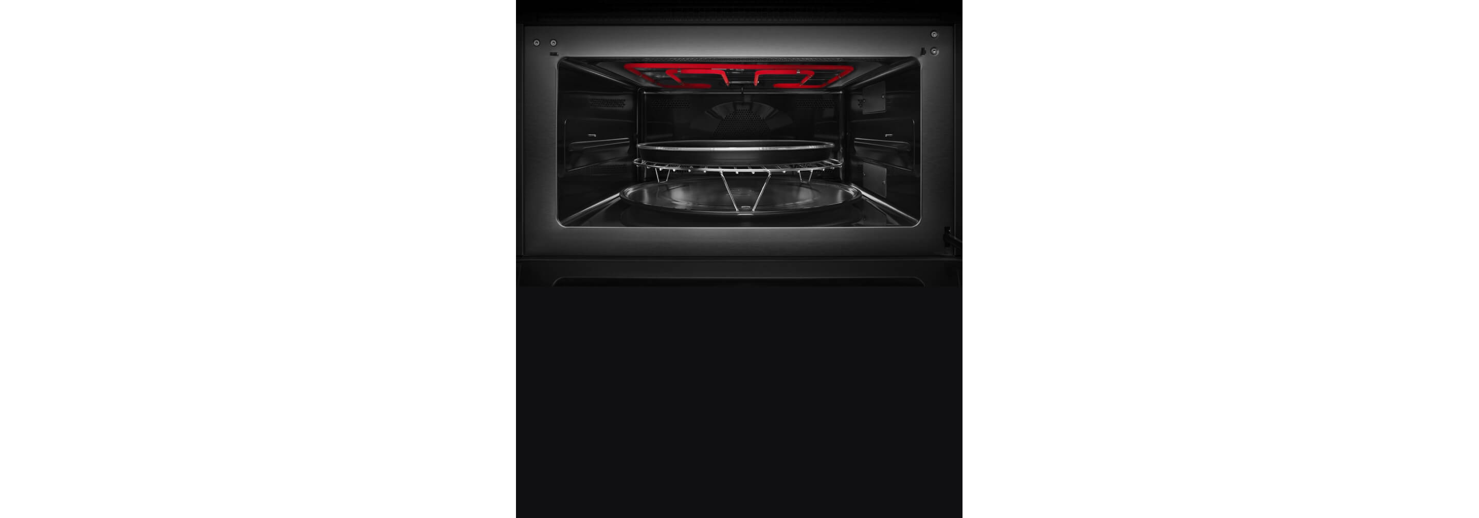 The interior of the built-in microwave or speed oven with the grill element activated.