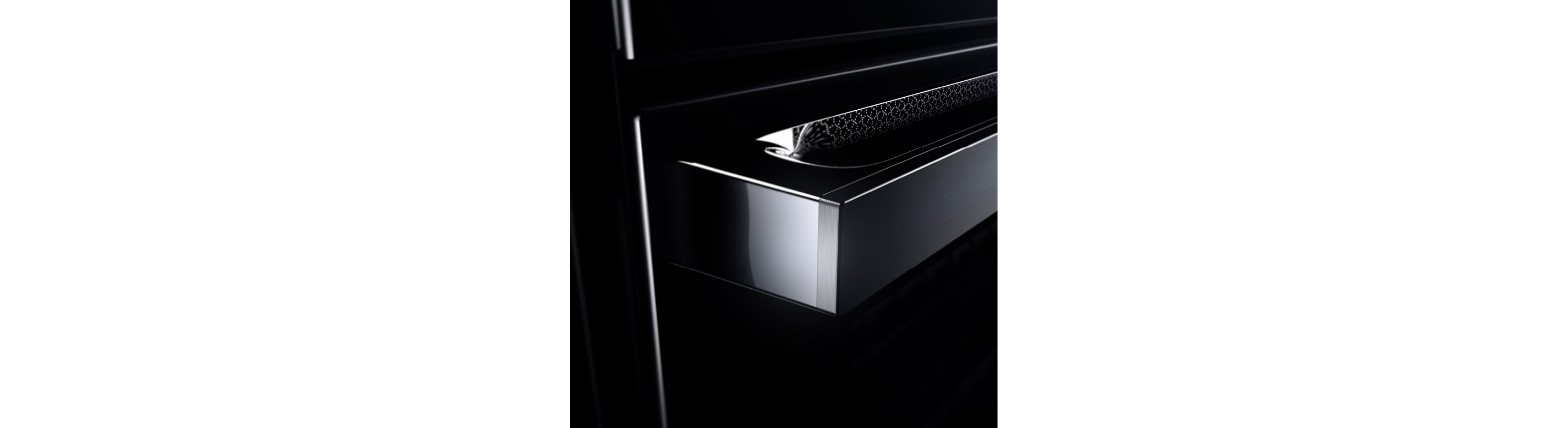The etched lace detail of the NOIR™ Design Expression reflecting on a JennAir range. 