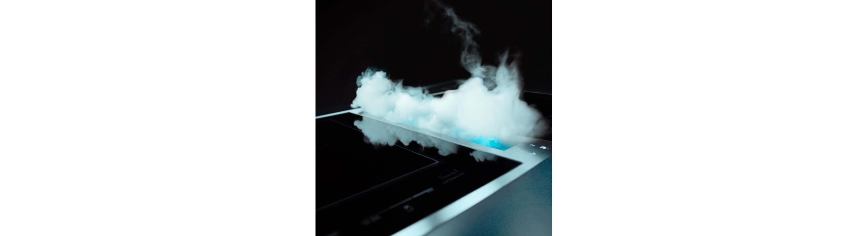 Smoke and steam being pulled into a JennAir downdraft ventilation system. 