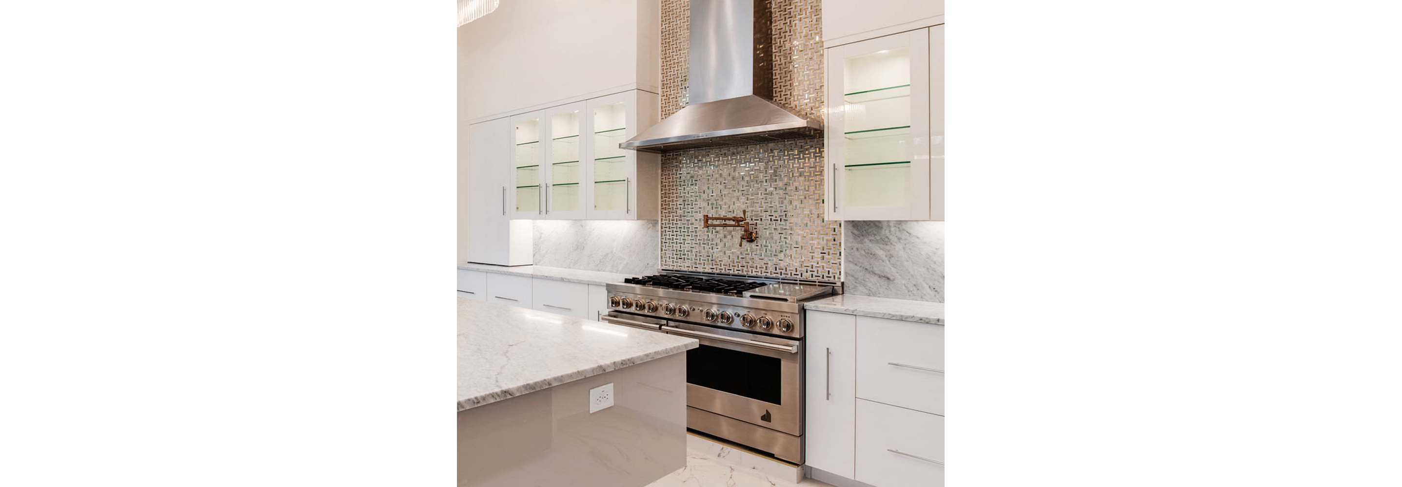 A JennAir professional-style range and ventilation system in a bright kitchen. 