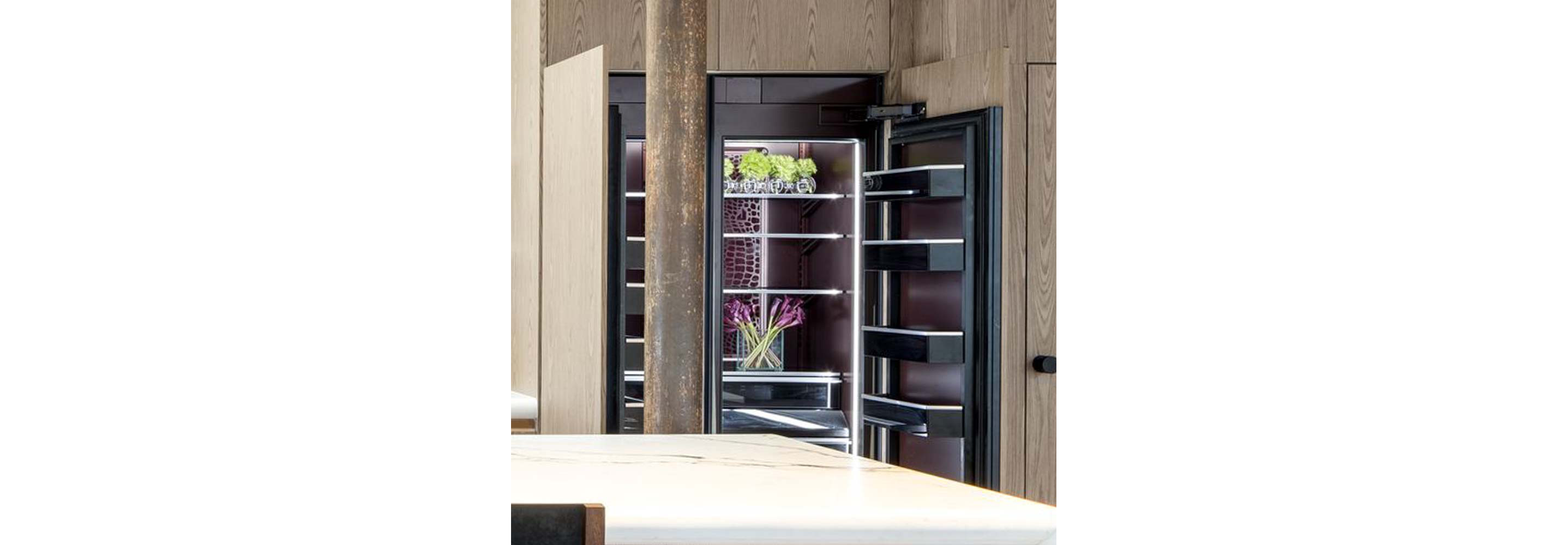 An open Burlesque refrigerator and freezer in a natural, modern kitchen. 