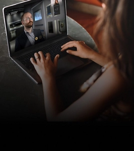 A person using a computer while meeting with a JennAir® Expert during a consultation. 