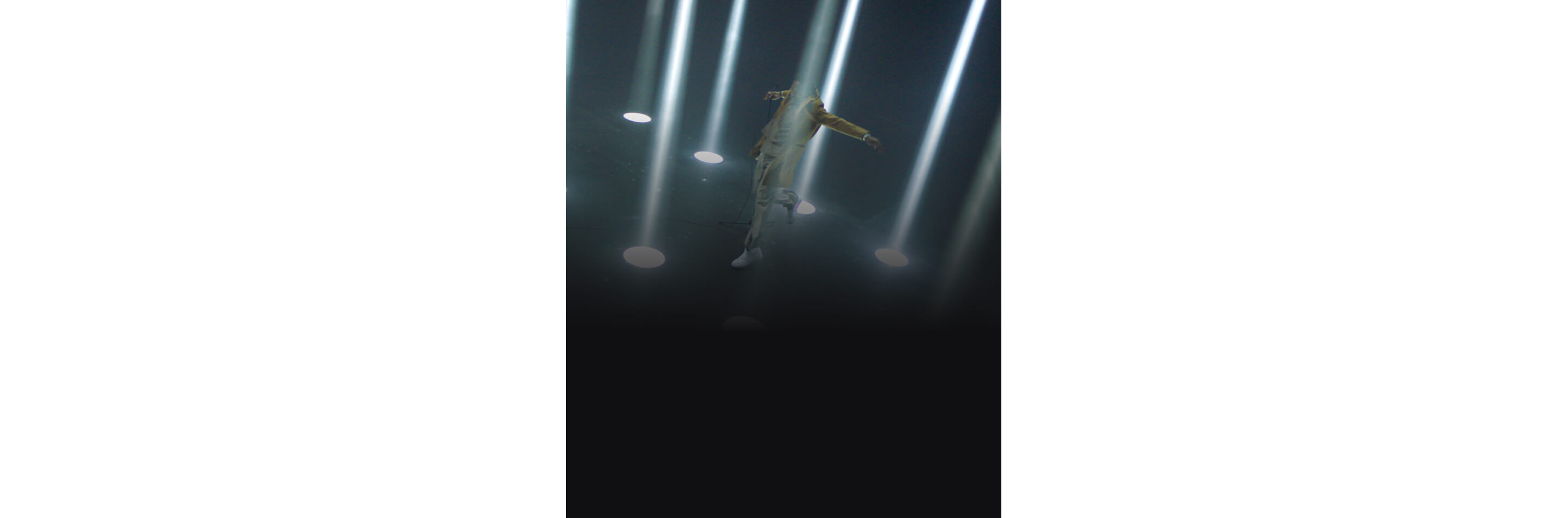A man standing amongst beams of light.